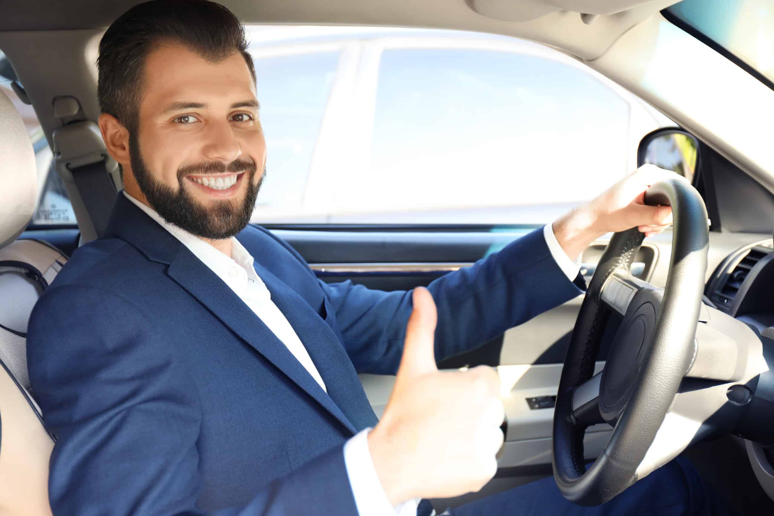 Young,Man,On,Driver's,Seat,Of,Car Reserva Aparcamiento en aeropuerto de alicante